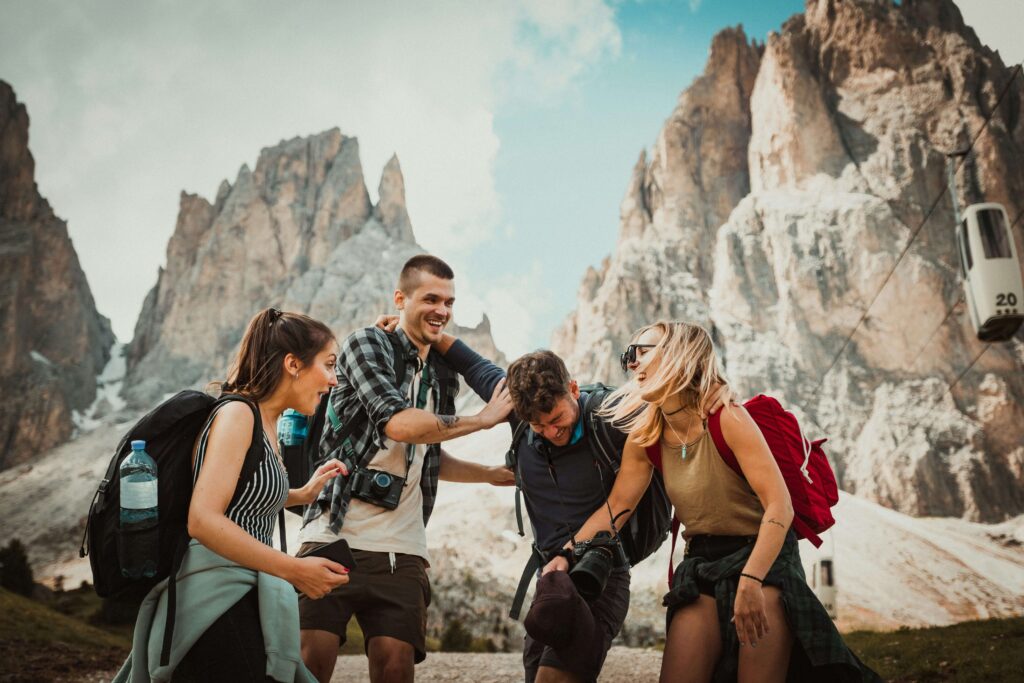 A group of male and female friends hiking in the mountains